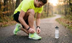 Läufer schnürt frühmorgens seine Laufschuhe – beste Tageszeit zum Laufen finden